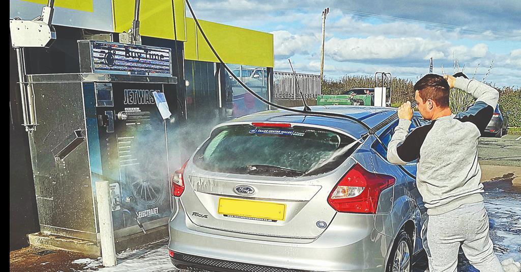 Self-service jet wash being used to clean a car